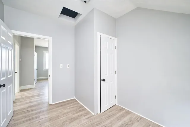 a view of a hallway with wooden floor