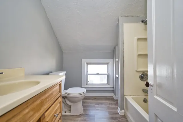 a bathroom with a sink a toilet and bathtub