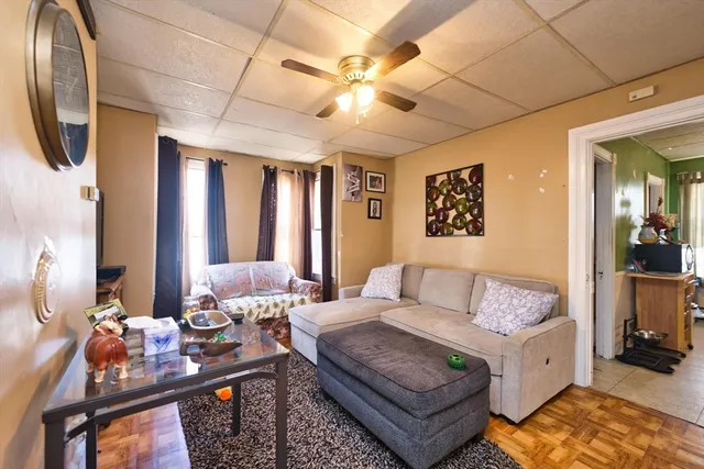 a living room with furniture and a chandelier