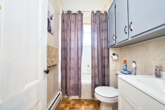 a bathroom with a toilet a sink and a shower