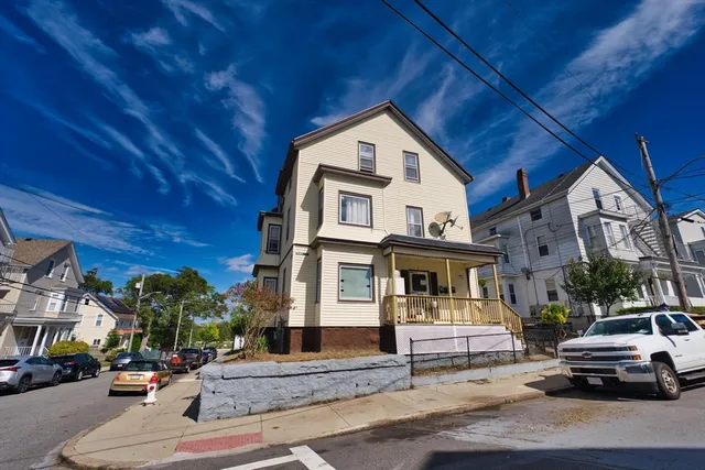 a front view of a residential apartment building with a yard