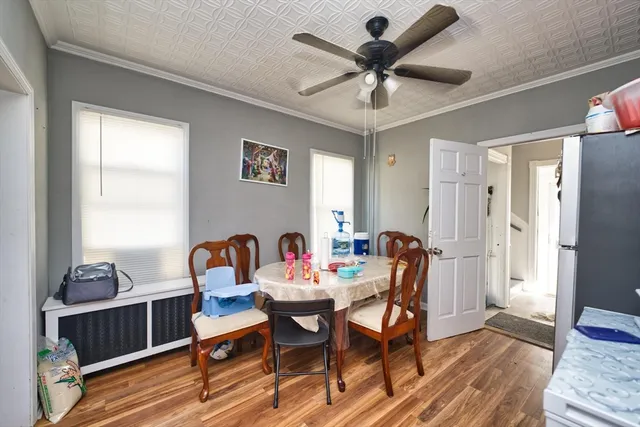 a dining room with furniture a chandelier and wooden floor