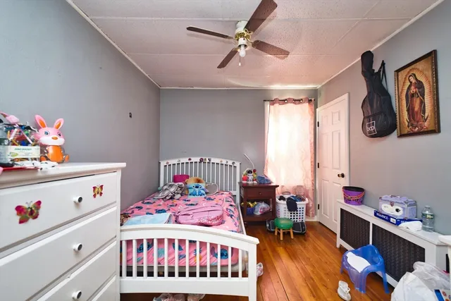 a bedroom with a bed and a dresser in it