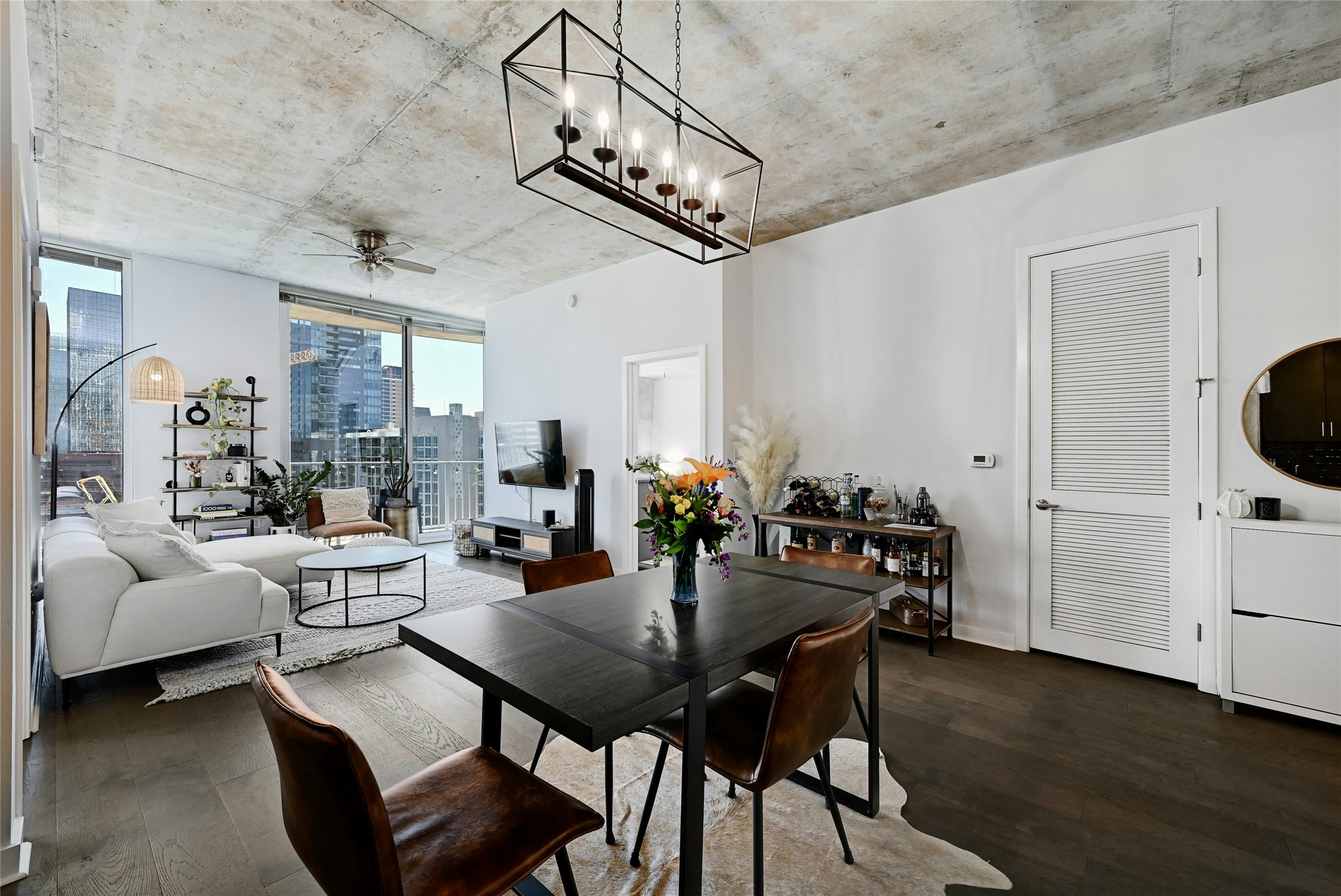 360 Nueces Street, Unit 1809 Austin, TX 78701 - Photo 4 of 25 Open-concept living area featuring a prominent dark wood-finish dining table with matching chairs