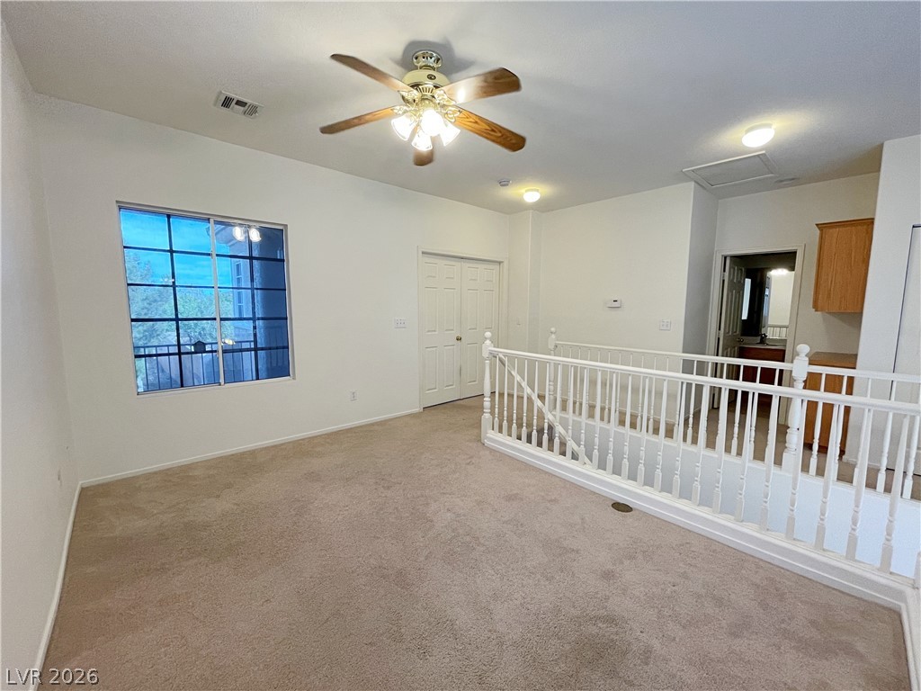 691 Principle Point Avenue Henderson, NV 89012 - Photo 17 of 30 A versatile open loft area provides additional living space with plush carpeting and a ceiling fan.