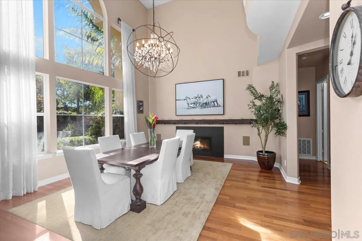 515 Verbena Court Encinitas, CA 92024 - Photo 13 of 42 a dining room with furniture a window and a chandelier