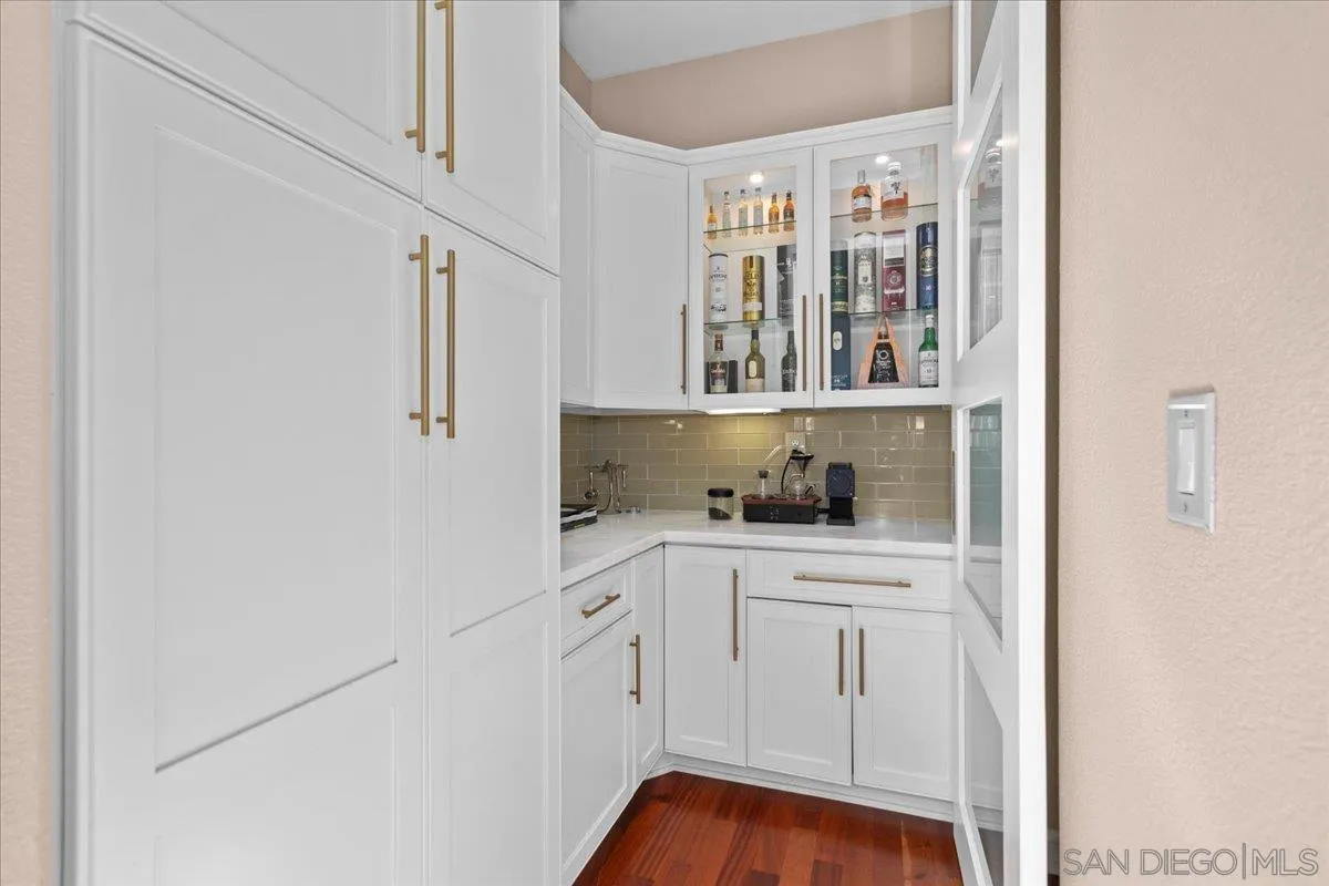 515 Verbena Court Encinitas, CA 92024 - Photo 15 of 42 a kitchen with white cabinets and window