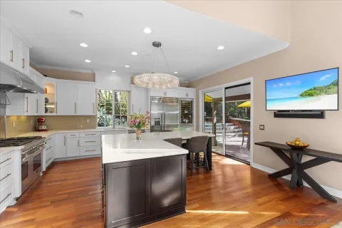 a large kitchen with a table and chairs in it