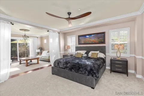 a spacious bedroom with a bed a table and large window