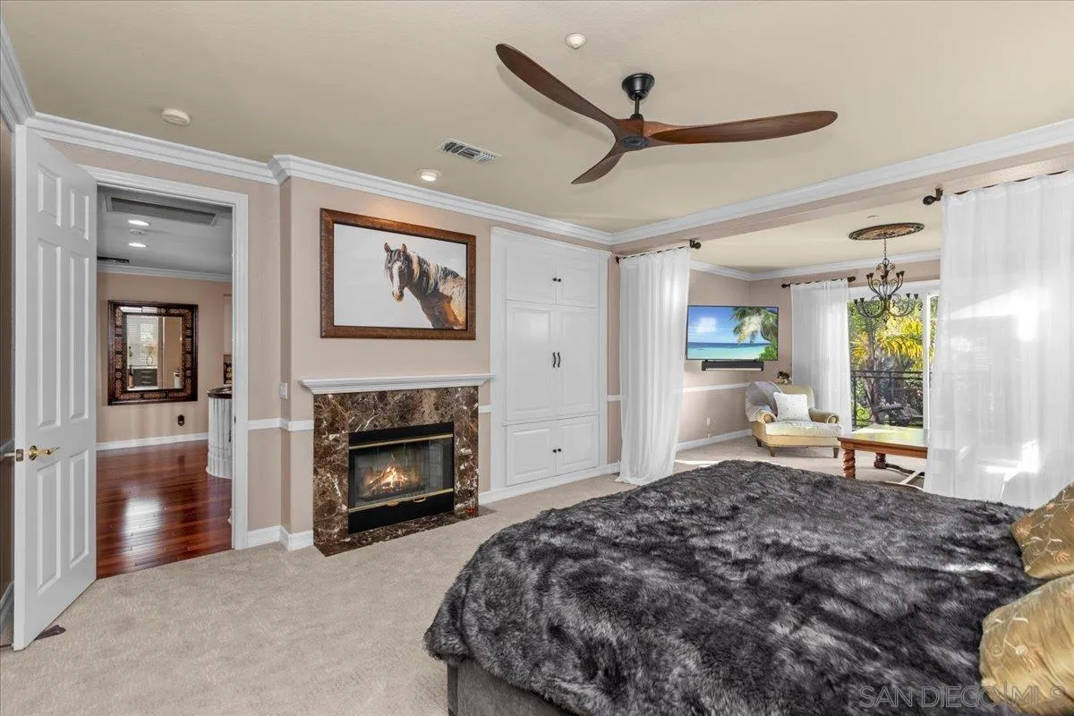 515 Verbena Court Encinitas, CA 92024 - Photo 25 of 42 a bedroom with a bed and a fireplace
