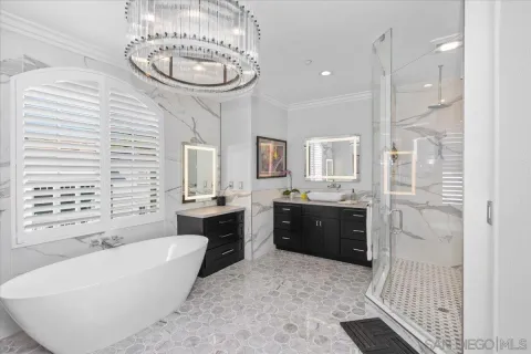 a spacious bathroom with a tub sink and mirror