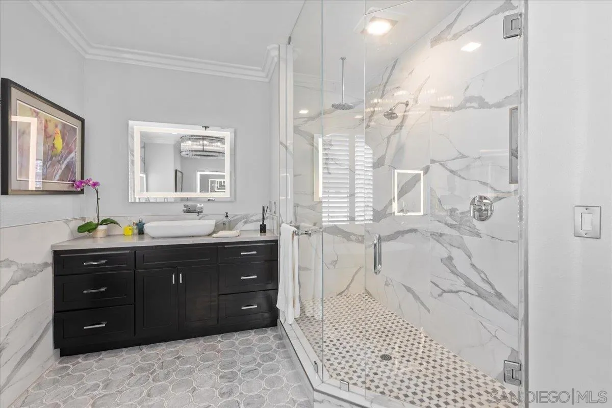 515 Verbena Court Encinitas, CA 92024 - Photo 30 of 42 a bathroom with a sink vanity granite tub shower and a mirror