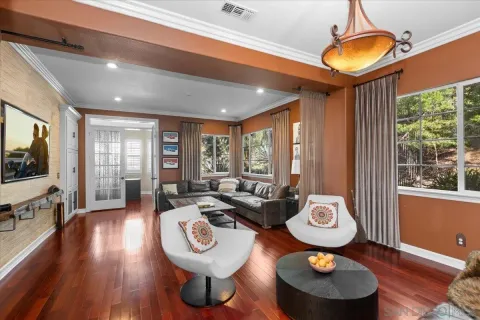a view of a dining room with furniture wooden floor and chandelier