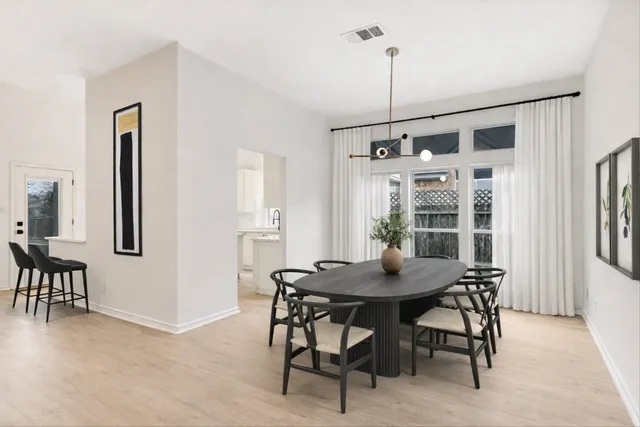 a kitchen with stainless steel appliances refrigerator and wooden floor