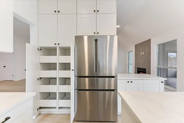 an empty room with ceiling fan and window