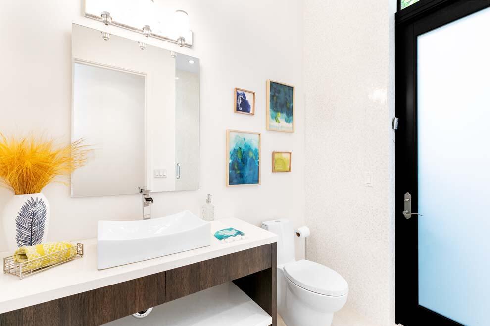 1540 Paslay Place Manalapan, FL 33462 - Photo 13 of 40 a bathroom with a sink a toilet and mirror