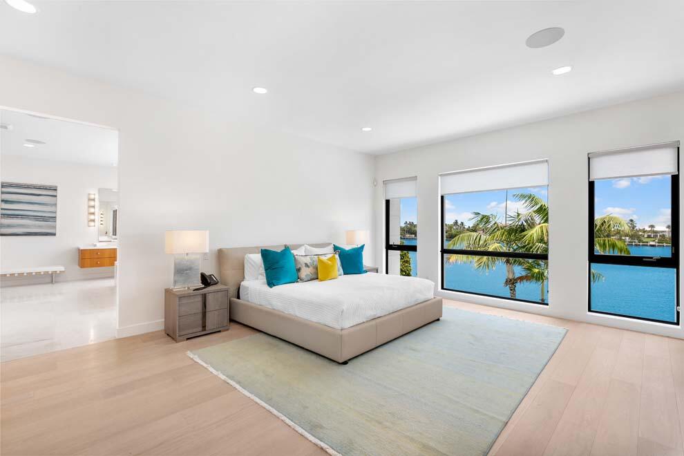 1540 Paslay Place Manalapan, FL 33462 - Photo 14 of 40 a bedroom with a large bed and a flat tv screen