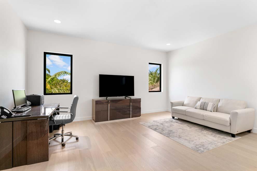 1540 Paslay Place Manalapan, FL 33462 - Photo 15 of 40 a living room with furniture and a flat screen tv