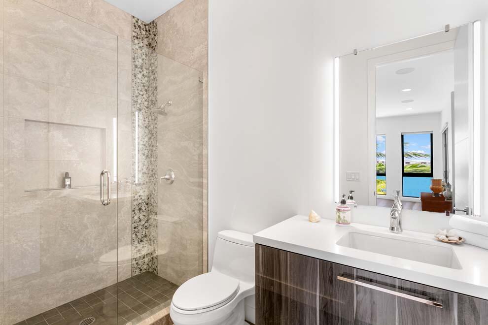 1540 Paslay Place Manalapan, FL 33462 - Photo 20 of 40 a bathroom with a sink toilet a mirror and shower