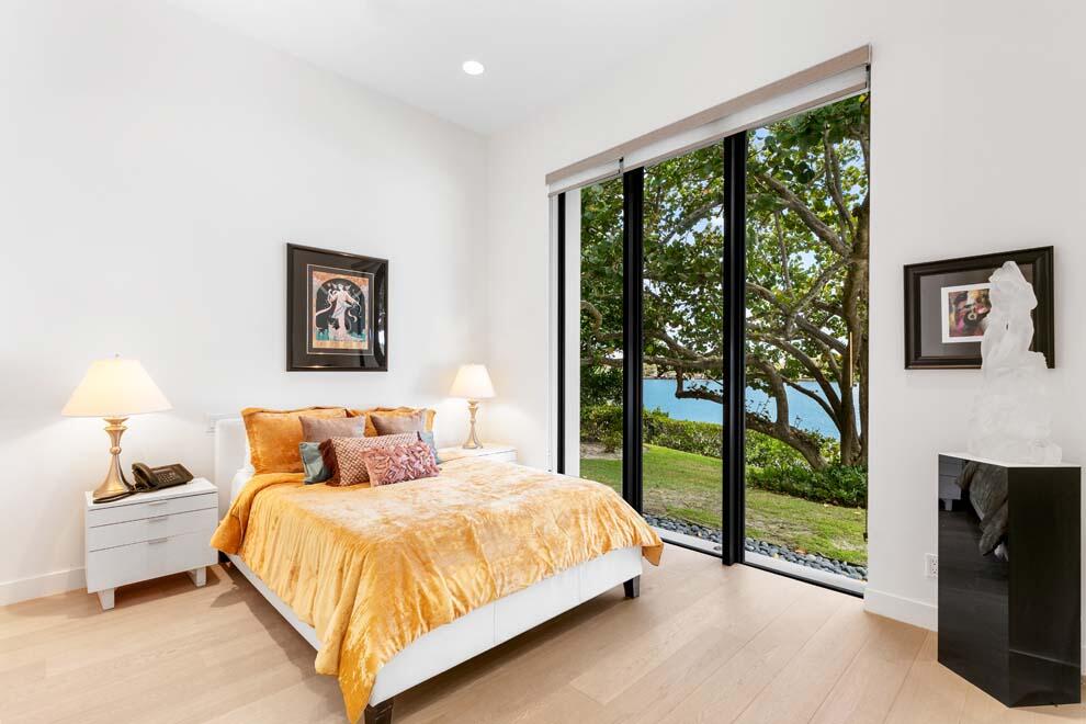 1540 Paslay Place Manalapan, FL 33462 - Photo 21 of 40 a bedroom with a bed and a view of balcony