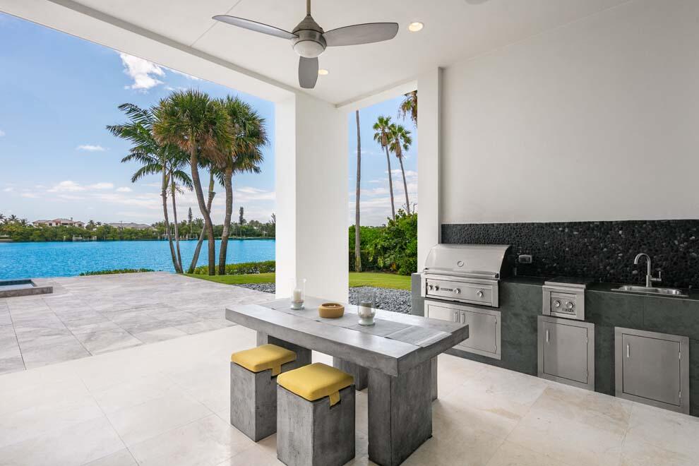 1540 Paslay Place Manalapan, FL 33462 - Photo 29 of 40 a kitchen with stainless steel appliances kitchen island a stove a sink and a counter space