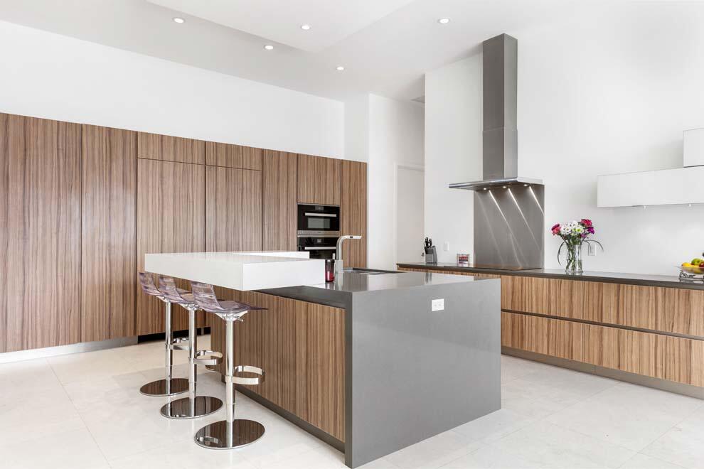 1540 Paslay Place Manalapan, FL 33462 - Photo 7 of 40 a kitchen with stainless steel appliances kitchen island a table chairs in it and wooden floors