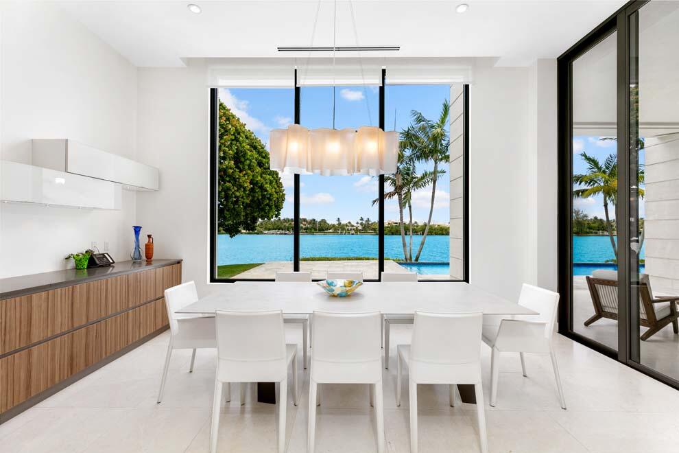 1540 Paslay Place Manalapan, FL 33462 - Photo 8 of 40 a dining room with furniture a chandelier and wooden floor