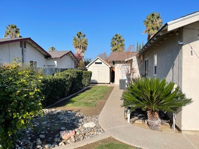 2212 Lavon Lane Ceres, CA 95307 - Photo 14 of 14 a white house with a white bed a garden and a chair