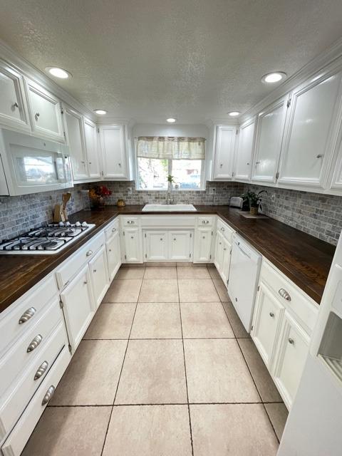 2212 Lavon Lane Ceres, CA 95307 - Photo 5 of 14 a large white kitchen with stainless steel appliances granite countertop a sink and cabinets