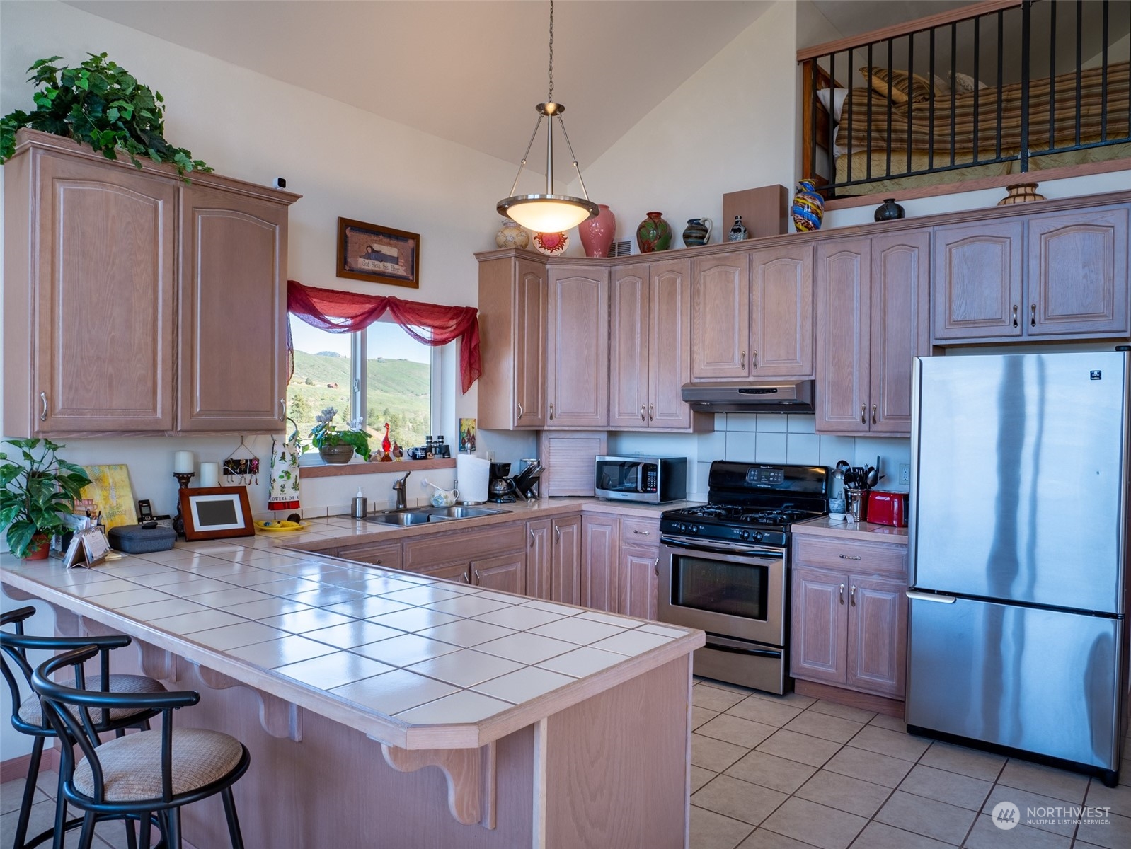 22 Rhinehart Road Winthrop, WA 98862 - Photo 5 of 23 a kitchen with stainless steel appliances granite countertop a stove refrigerator sink and cabinets