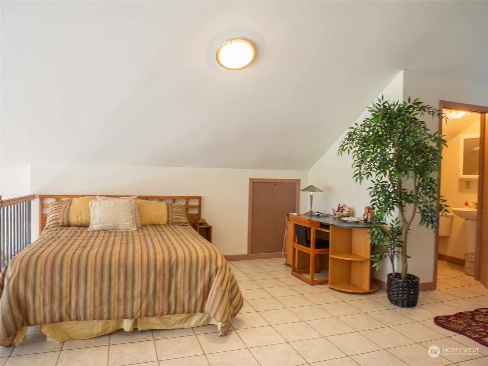 22 Rhinehart Road Winthrop, WA 98862 - Photo 8 of 23 a bedroom with a bed and a potted plant