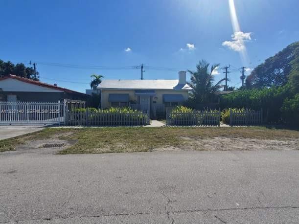 6756 Southwest 39th Terrace Miami, FL 33155 - Photo 2 of 2 a view of a house with a yard and garage