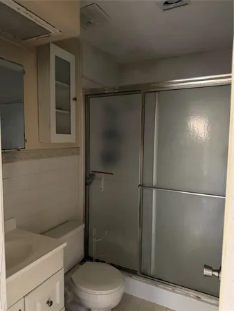 a bathroom with a toilet and a shower