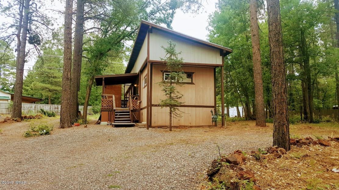 4381 East Blue Ridge Loop, Unit 3 Pinetop, AZ 85935 - Photo 1 of 16 a house with trees in the background