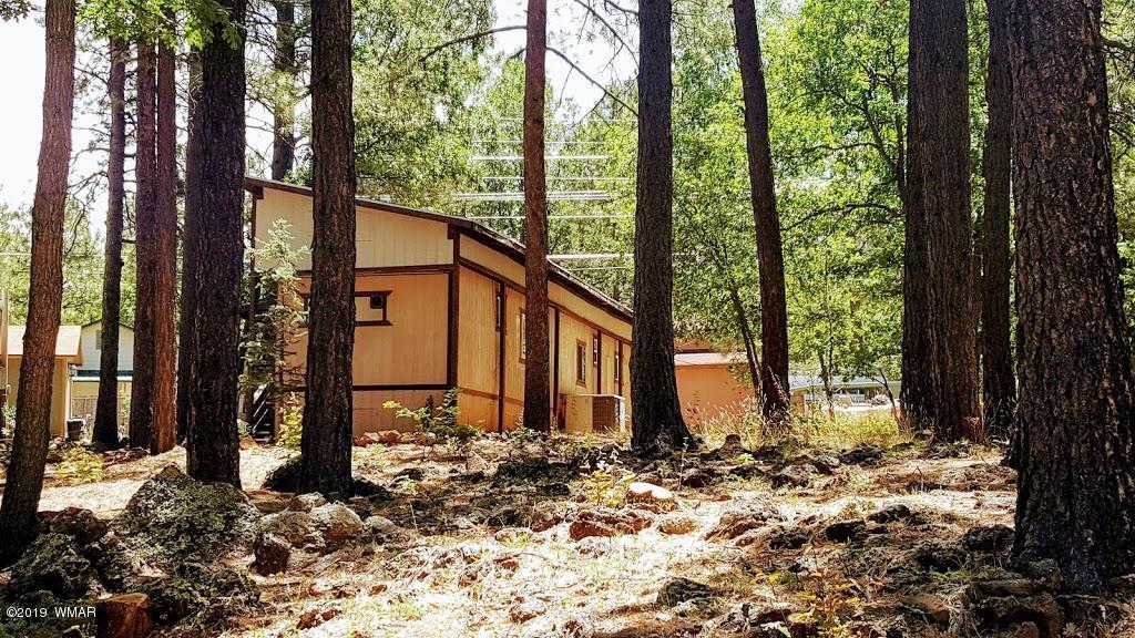 4381 East Blue Ridge Loop, Unit 3 Pinetop, AZ 85935 - Photo 2 of 16 a view of a house with backyard and trees