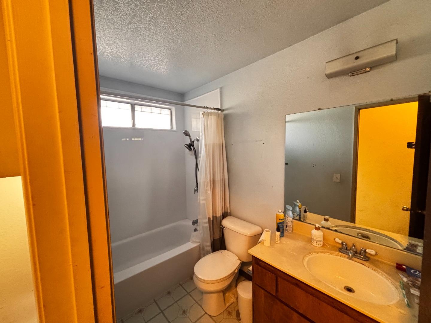 1752 Duffy Way San Jose, CA 95116 - Photo 12 of 14 a bathroom with a double vanity sink toilet mirror and shower