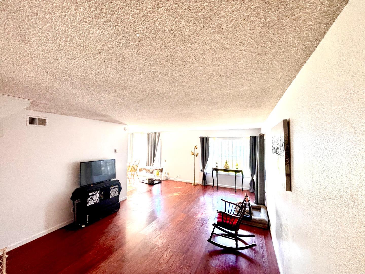 1752 Duffy Way San Jose, CA 95116 - Photo 4 of 14 a living room with furniture and a flat screen tv