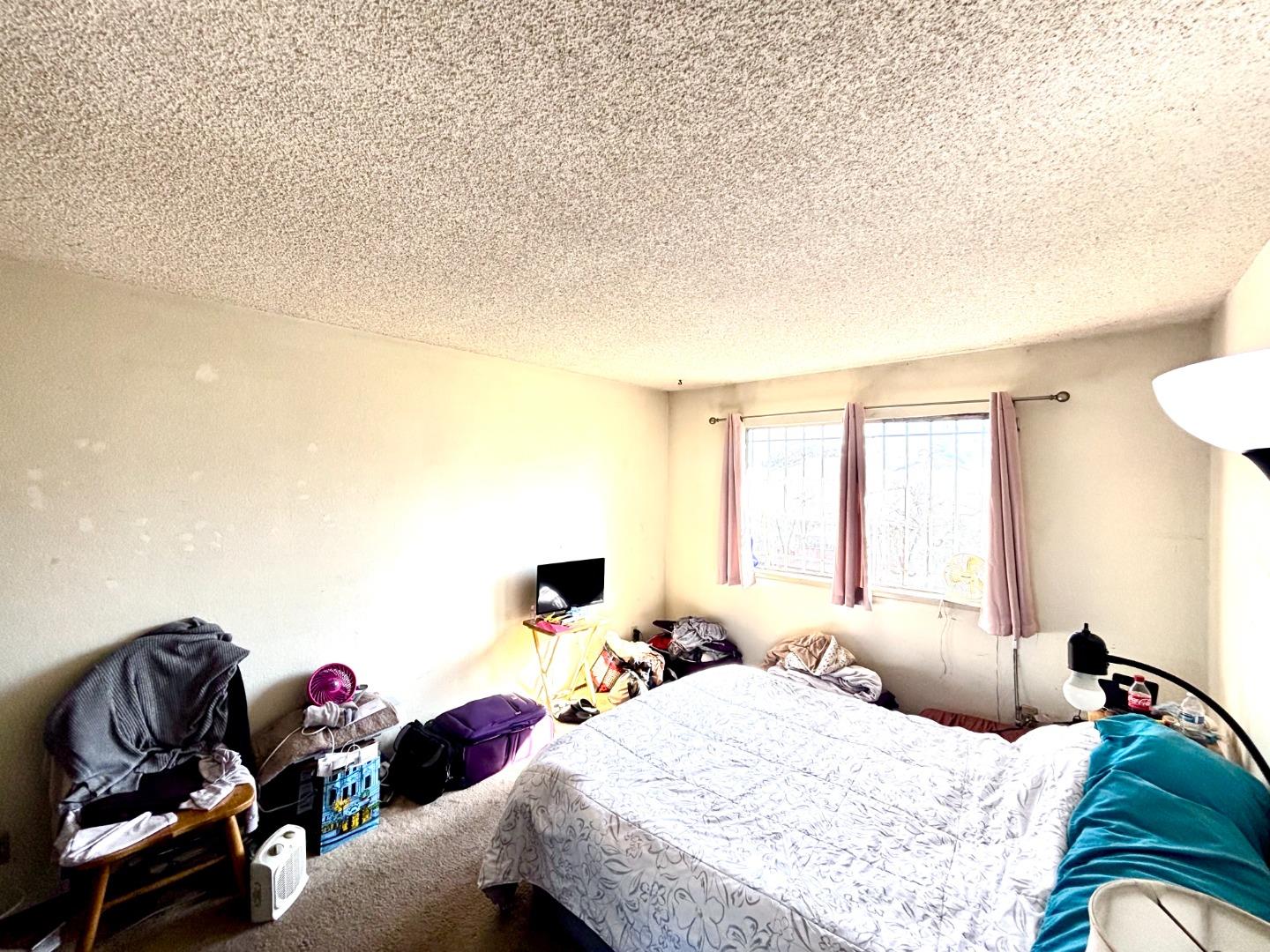 1752 Duffy Way San Jose, CA 95116 - Photo 10 of 14 a bedroom with a bed and couch