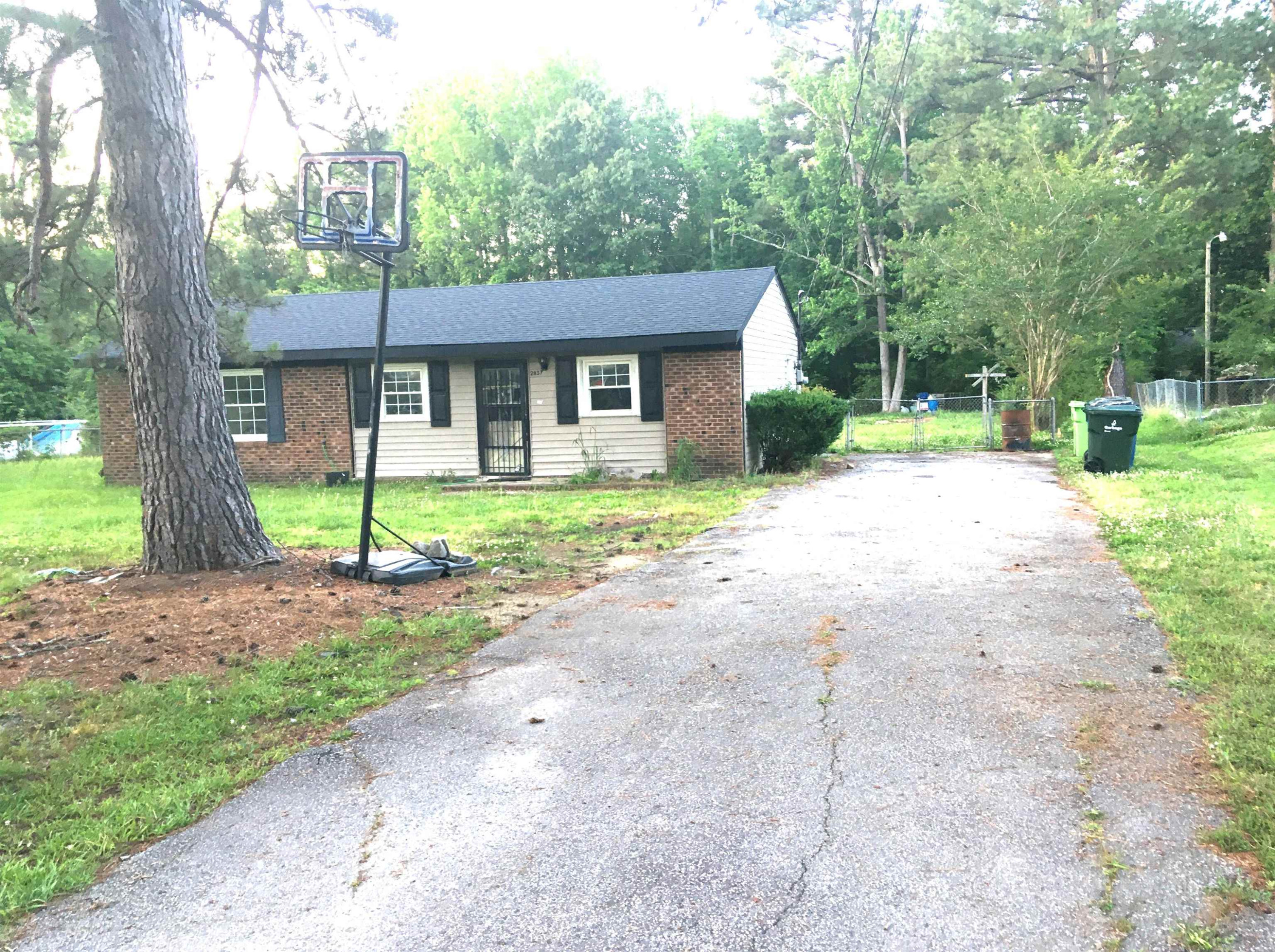2837 Providence Road Raleigh, NC 27610 - Photo 2 of 6 a view of a house with a yard and large trees