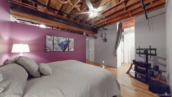 a bedroom with a bed with wooden floor