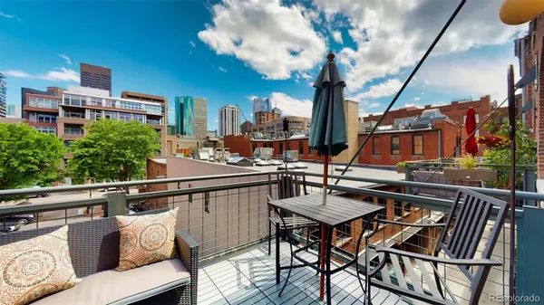 a view of a chairs and table in the balcony