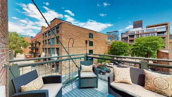 a view of a roof deck with couches and potted plants