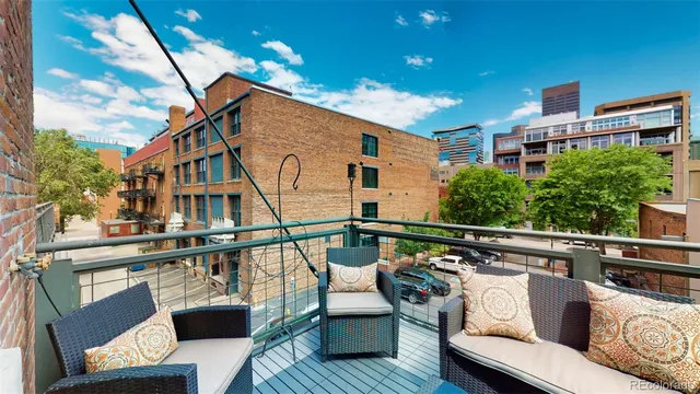 a view of a roof deck with couches and potted plants