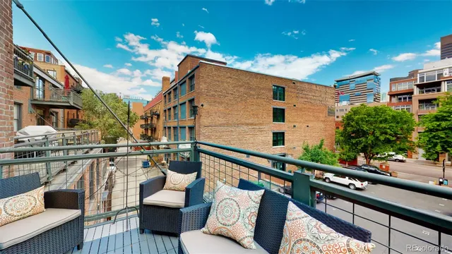 a balcony view with couple of chairs