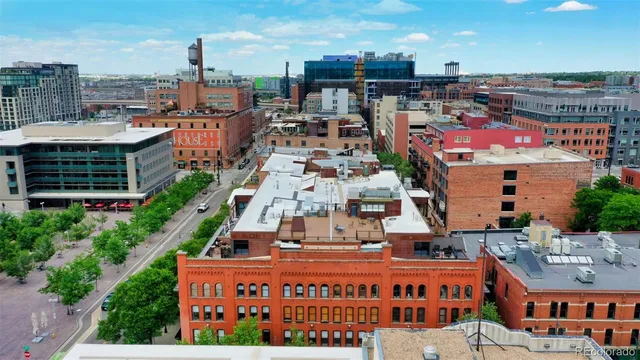 an aerial view of multi story residential building with yard