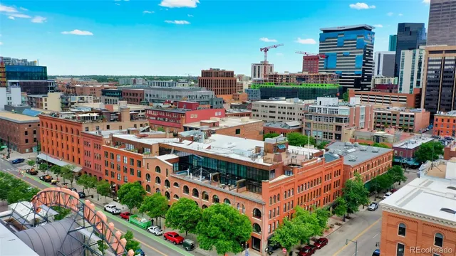 a building view with tall trees and outdoor seating space