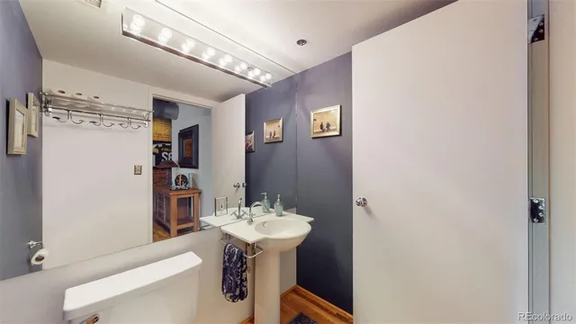 a bathroom with a sink a mirror and a toilet