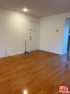 a kitchen with cabinets and white appliances