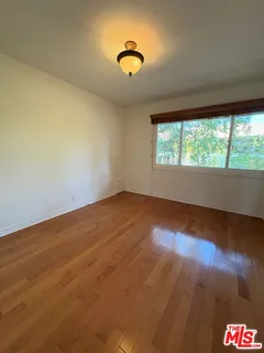 a bathroom with a sink a toilet a mirror a vanity and bathtub