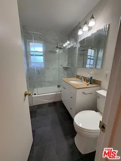 a view of backyard with table and chairs and a large tree